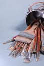 A Bunch of Rustic Artist Brushes in a Metal Bucket