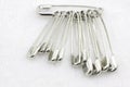 Bunch of safety pins on fabric Royalty Free Stock Photo