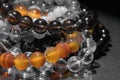 Bunch of semiprecious gemstone bracelets on black background - cornelian, amethyst, quartz