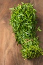 Bunch of sessile joyweed leaves or dwarf copperleaf on a wooden table top