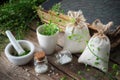 Bunch of shepherds purse, homeopathic bottle, mortar and old book.