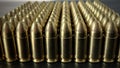 Bunch of shiny 9 mm brass ammo on dark wooden desk
