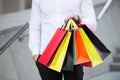Bunch of shopping bags in male hands outdoor, close up. Shopping tips. Successful shopping expedition. What a waste. Buy Royalty Free Stock Photo