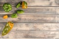 Bunch of small and big bell peppers on faded wooden table, top view. Green and yellow fresh vegetables. Food or healthy