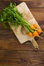 Bunch of small, round carrots (Parisian Heirloom Carrots) on wooden background