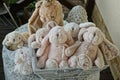 A bunch of soft plush toys pink and gray hares in a box