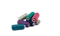 Bunch of spools with colored threads on a white background.