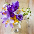 Bunch of spring flowers. Crocus and Snowdrops on the wooden back