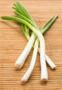 Bunch of spring onions on a wooden table Royalty Free Stock Photo