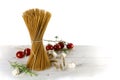 Bunch of standing wholemeal spaghetti on white wood with some to Royalty Free Stock Photo