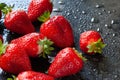 Bunch of strawberries close up. Wet ripe strawberries on a black background. Red berries with drops of water. Selective focus Royalty Free Stock Photo