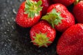 Bunch of strawberries. Wet ripe strawberry on a black background close up. Red berries with water drops. Selective focus Royalty Free Stock Photo