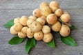 Bunch of sweet Lanzones or Longong fruit and leaves on the table