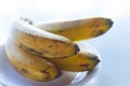 Bunch of sweet ripe bananas. Tasty bananas on white plate on table. Tropical fruits concept. Exotic breakfast on tropical vacation Royalty Free Stock Photo