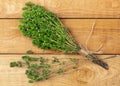 Bunch of thyme twigs isolated on wooden table Royalty Free Stock Photo