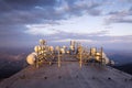 Bunch of transmitters and aerials on the telecommunication tower during sunset Royalty Free Stock Photo