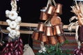 Bunch of Turkish embossed cooper bronze coffee pots and braids of white garlic and red onions hanging in the oriental market