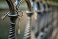 A bunch of two metal old vintage door keys hanging on a cast-iron fence of artistic casting in a park with a blurred background Royalty Free Stock Photo