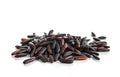 A bunch of unpolished black rice grains isolated on white background.