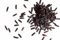A bunch of unpolished black rice grains isolated on white