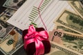 A bunch of US dollars in a pink ribbon, a beautiful background. Royalty Free Stock Photo