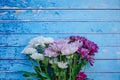 Blue wooden background with a bunch of dahlia flowers, free space for text over the flowers Royalty Free Stock Photo