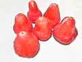 a bunch of water guava lying in bright red looks fresh