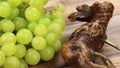 Bunch of white grapes and corkscrews in close-up