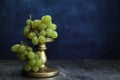 Bunch of white grapes on golden pedestal