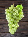 Bunch of white grapes. Old wood on the background