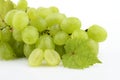 Bunch of white grapes on white with vine leaves branch Royalty Free Stock Photo