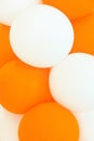 Bunch of white and orange air balloons. Kids birthday party decoration celebration fun concept.Abstract background template Royalty Free Stock Photo