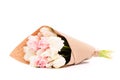 Bunch of white and pink double tulips wrapped in recycled brown paper isolated on white background.