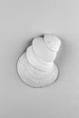 A bunch of white seashells on a grey background, close-up view from above, black and white monochrome photo. Royalty Free Stock Photo