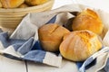 Bunch of whole, fresh baked wheat buns in baking basket and on k Royalty Free Stock Photo