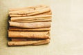 A bunch of whole sticks of fragrant cinnamon on a wooden rural table. copyspace. composition of seasoning and slide flavoring