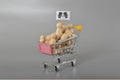 A bunch of wooden figures loaded in a shopping cart represent the concept of human trafficking or immoral actions Royalty Free Stock Photo