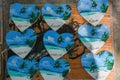 Bunch of wooden heart shaped souvenirs with landscapes of Maldives on it