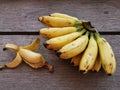 A bunch of yellow banana on wooden plank. Lighting nature background.