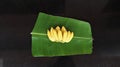 Bunch of yellow color bananas in plantain leaf