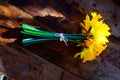 Bunch of yellow daffodils tied together with string on a wooden