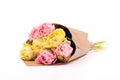 Bunch of yellow and pink double tulips wrapped in recycled brown paper isolated on white background.