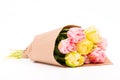 Bunch of yellow and pink double tulips wrapped in recycled brown paper isolated on white background.