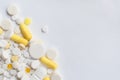 A bunch of yellow and white tablets and pills isolated on a white background close up. Royalty Free Stock Photo