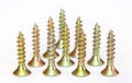 Bunch of yellow zinc coated philips flat head cross screws - fasteners Royalty Free Stock Photo