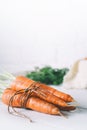 Bunch of young carrots with green tops on white wooden vintage table, healthy food on mock up background top view, Royalty Free Stock Photo