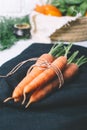 Bunch of young carrots with green tops on white wooden vintage table, healthy food on mock up background Royalty Free Stock Photo