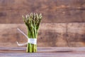 Bunches of asparagus tied on a wood background. Royalty Free Stock Photo