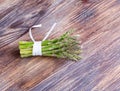 Bunches of asparagus tied on a wood background. Royalty Free Stock Photo