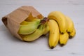 bunches of banana fruits in brown paper grocery bag isolated on white background Royalty Free Stock Photo